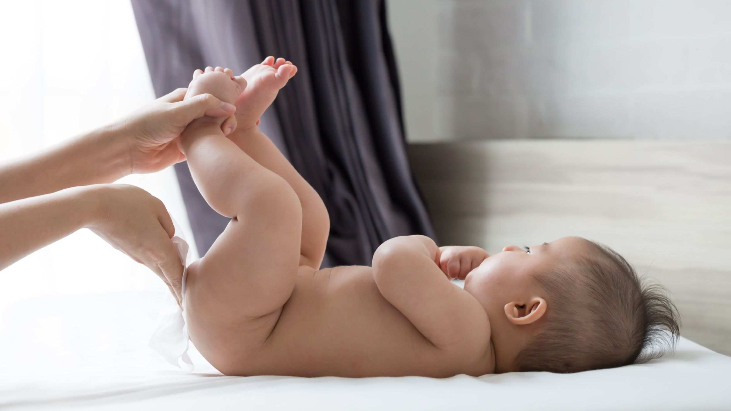 Mom wiping a baby's bottom