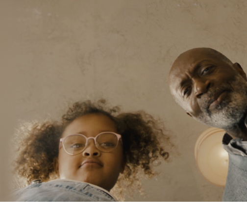 Smling granddaughter and grandfather looking into a toilet