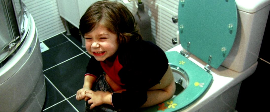 Toddler sitting on a toilet